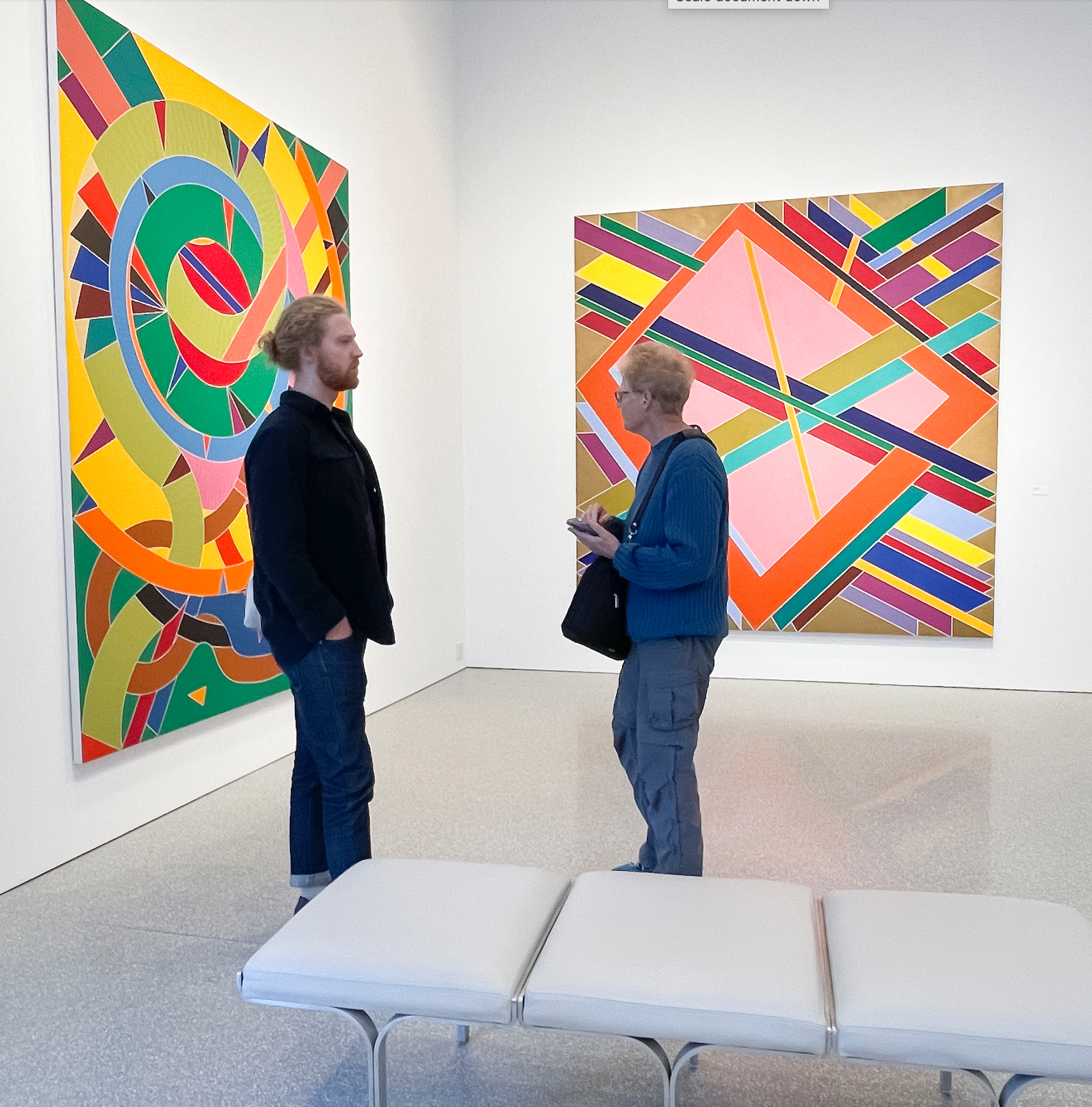 Two people standing in a New York City gallery